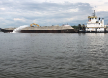 A barge blasts oyster hash into a river. 