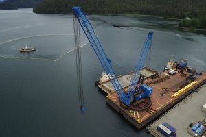 The barge Salvation, the KP-2 deck barge, and two tugs tied up at Samson’s dock. The Alaskan Salvor located inside the containment boom around the tug Powhatan. (Photo provided by Samson Tug & Barge; June 4, 2017)